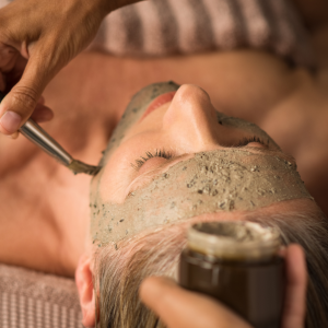 close up of application of a clay face mask