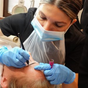 tutor demonstrating microblading treatment