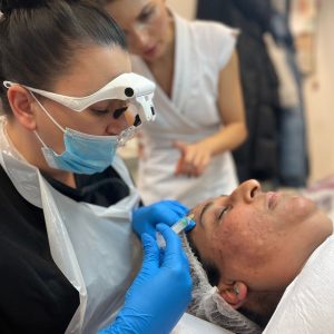 student injecting mesotherapy treatment, supervised by tutor