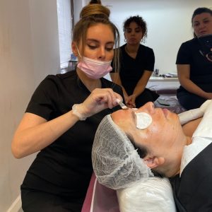 tutor demonstrating chemical skin peel application