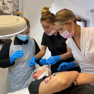 mesotherapy tutors showing injection site to a student