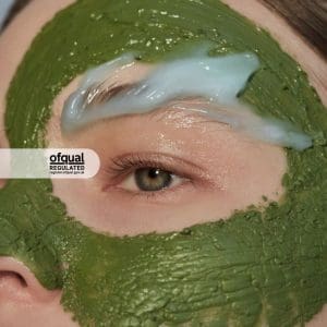 close up of green face mask on face